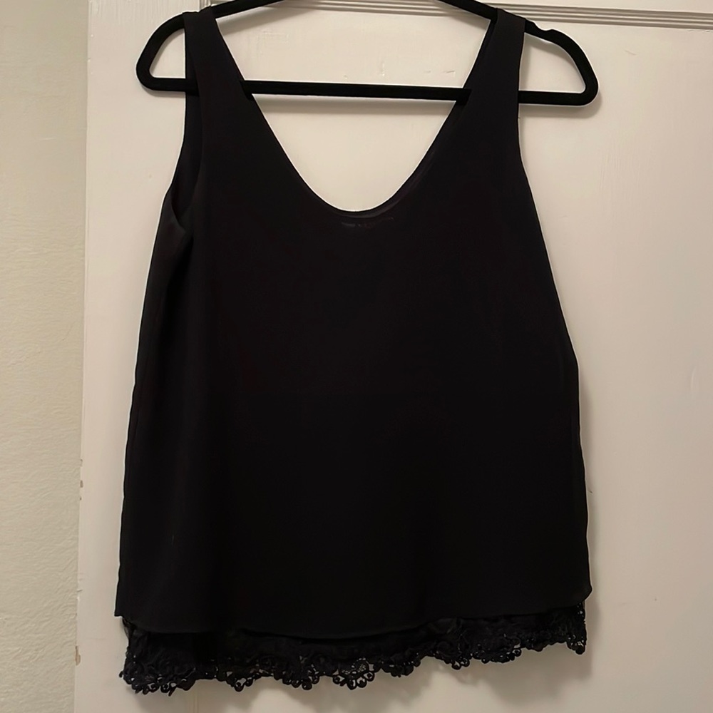 Black polyester tank with lace peekaboo bottom layer